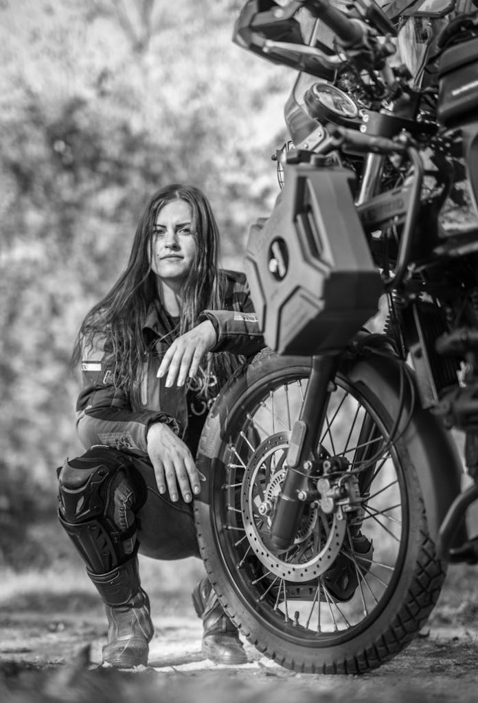 Dynamic black and white portrait of a woman with a motorcycle, exuding confidence and adventure. For Strengthening The Set